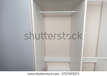 A carpenter assembling a wardrobe in a vestibule, a precise handiwork.