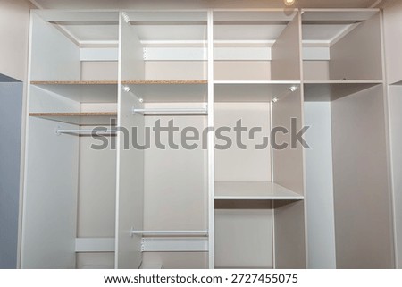 A carpenter assembling a wardrobe in a vestibule, a precise handiwork.