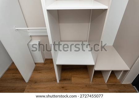 A carpenter assembling a wardrobe in a vestibule, a precise handiwork.