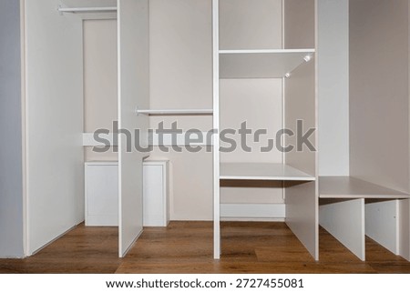 A carpenter assembling a wardrobe in a vestibule, a precise handiwork.