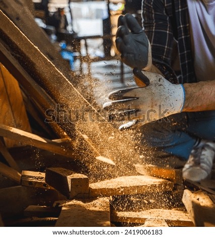 Carpenter blowing sawdust while working in carpentry wood shop