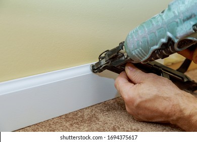 Carpenter Brad Using Air Nail Gun To Base Moulding Trim, With Room Renovation New House Finishing