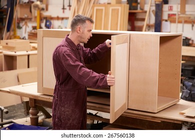 Carpenter Building Furniture In Workshop
