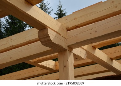 A Carpenter Built A Log Cabin With Rough Hewn Beams. Wood Planing Was Not Done Before. Authentic Craftsmanship Wooden Log Cabin. Mortises For Placing Roof Beams. Gouging Wood, Ax, Cut