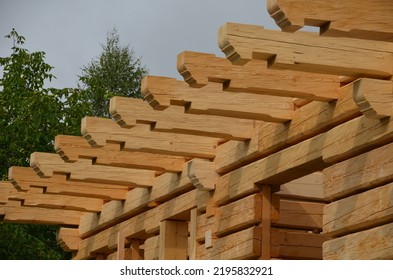 a carpenter built a log cabin with rough hewn beams. wood planing was not done before. authentic craftsmanship wooden log cabin. mortises for placing roof beams. gouging wood, ax, cut - Shutterstock ID 2195832921