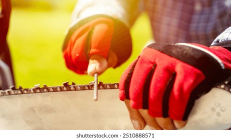 a carpenter or craftsman sharpens a chain at a chainsaw - Powered by Shutterstock