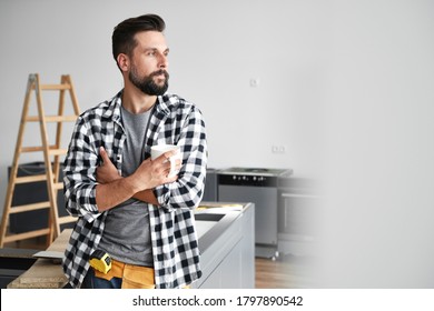 Carpenter with cup of coffee during breaks in work                                - Powered by Shutterstock