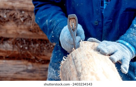 a carpenter cuts a log with an axe. High quality photo