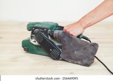 Carpenter Doing Parquet Wood Floor Polishing Maintenance