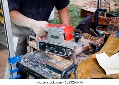 
A carpenter is doing the work to create a lumber product. As various appliances.