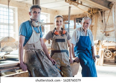 Carpenter Family Business With Generations In The Workshop Having A Break