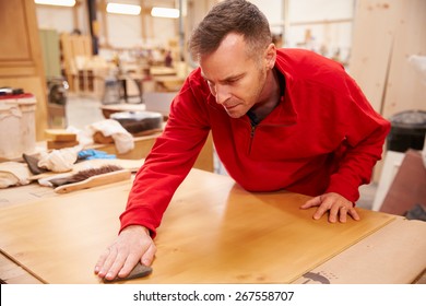 Carpenter Finishing Wood In Carpentry Workshop