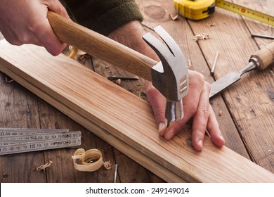 carpenter hammer a nail