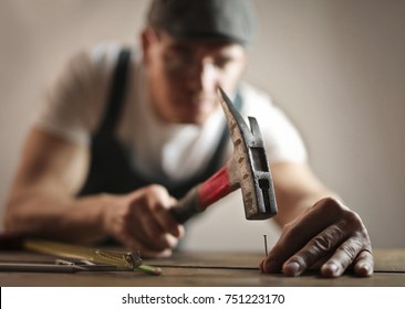 Carpenter hammering a nail

