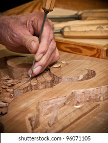 Carpenter Hand Carving Wood With Care