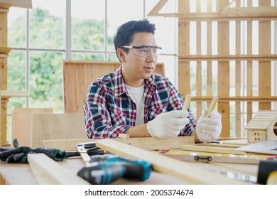 Carpenter Making Birdhouse. Carpenter Using Chisel And Hammer. Young Male Carpenter Working Wood Workshop.