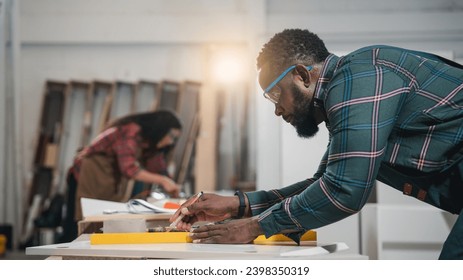 Carpenter making woodworks handcrafted furniture in wood workshop. Furniture Designer working on woodworking machines in furniture factory. - Powered by Shutterstock