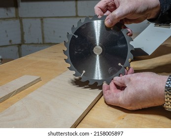 carpenter man holding a replacement carbon steel circular saw blade