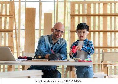 A Carpenter Man Teaching The Boy Doing Carpentry Work At Home