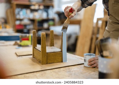 Carpenter painting furniture in her workshop, close-up
 - Powered by Shutterstock