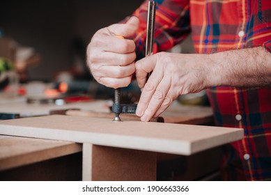 Carpenter Placing The Wood Of A Piece Of Furniture To Open Holes In It So That It Does Not Move