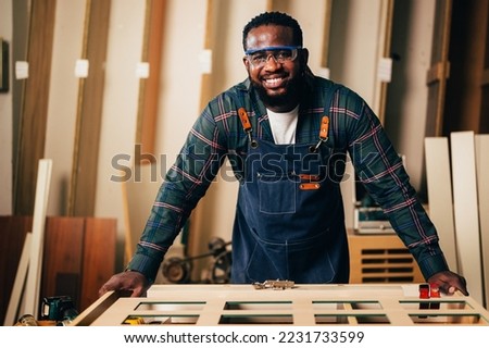 Carpenter portrait, Carpenter working creating furniture in workshop. carpentry and furniture handicrafts.