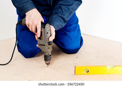 Carpenter Screw Screwdriver Spin Into A Sheet Of Plywood. Repair Floor 