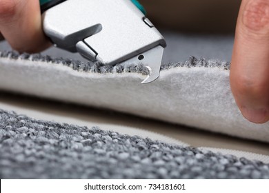 Carpenter Shaping Carpet Using Carpenter Tools To Lay Carpet At Home