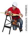 A carpenter taking measures.