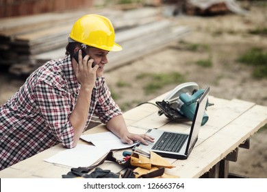 Carpenter Talking On Mobile Phone