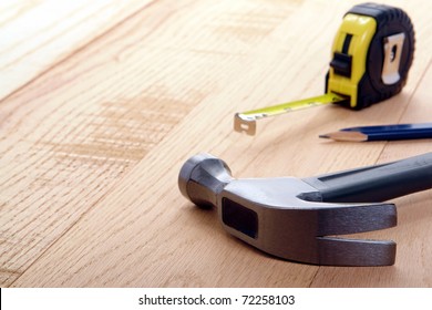 Carpenter tools on oak wood boards with with claw hammer and retractable  tape measure