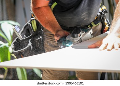 A Carpenter/ tradesman working on a job site with his tools. 