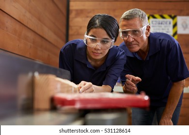 Carpenter Training Female Apprentice To Use Plane - Shutterstock ID 531128614