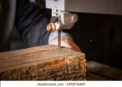 Carpenter Using Bandsaw To Cut Old Reclaimed Oak Wood Beam