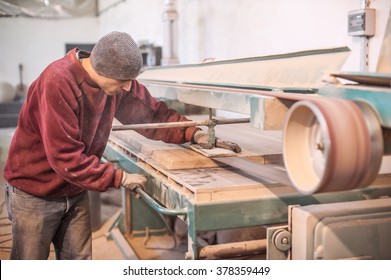 Carpenter using belt sander. Carpenter sanding a wood with belt sander