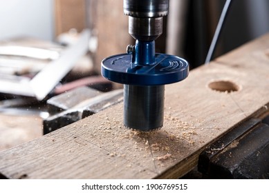 carpenter using blade hole saw cut wood plank
