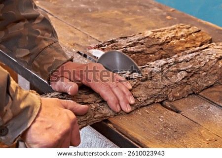 Carpenter using circular saw cutting wooden board into pieces. Male worker building wooden frame house. Carpentry concepts.