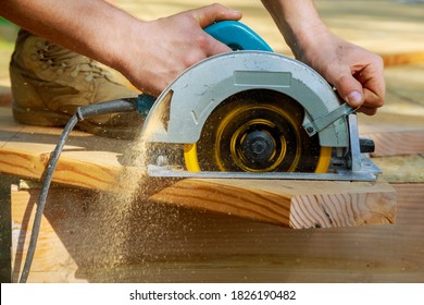 Carpenter using circular saw for wood beam a new home constructiion project - Powered by Shutterstock