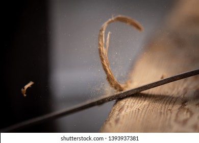 Carpenter Using A Manual Bark Peeler To Shape An Old Reclaimed Oak Wood Beam