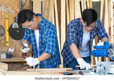 Carpenter using planning machine at carpentry shop. Wood processing apprenticeship at carpentry shop.