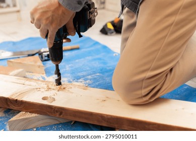 A carpenter using power tools to work with wood