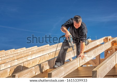 Carpenter at Work, Fixing a Rafter with a Long Screw