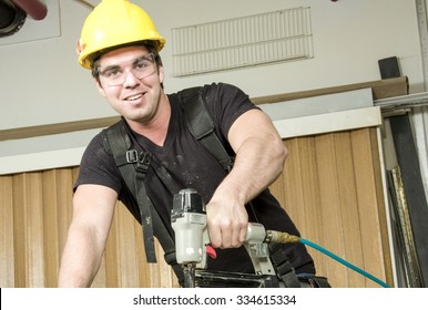 A Carpenter at work on job using power tool