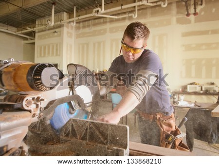Carpenter at work on job using power tool