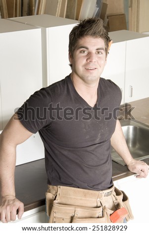 Carpenter at work on job using power tool