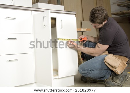 Carpenter at work on job using power tool