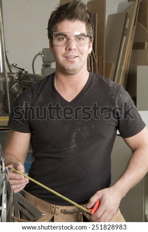 Carpenter at work on job using power tool