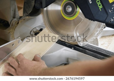 Carpenter at work outdoors on a  constructionsite. Craftsman at work with different tools. Building materials. Sawing machine