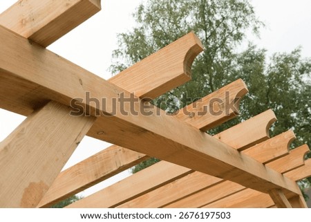 Carpenter at work outdoors on a  constructionsite. Craftsman at work with different tools. Building materials. Wood construction with beams
