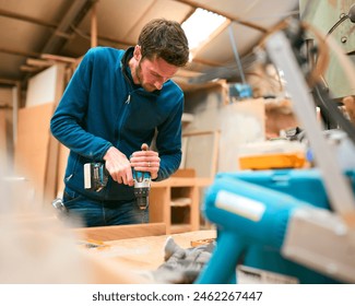 Carpenter At Workbench In Workshop Using Cordless Electric Drill - Powered by Shutterstock